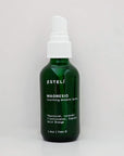 Green bottle of Esteló Magnesio Soothing Mineral Spray on a light gray background