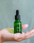 ESTELÍ Verano Body Oil mini resting in an open hand