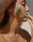 Woman using Esteli Green Aventurine Facial Roller
