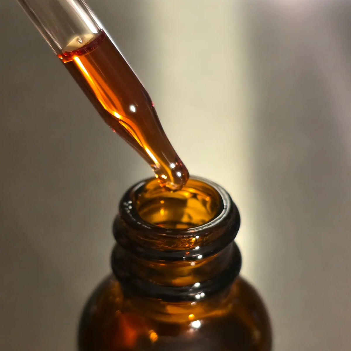 Close-up of concentrated botanical extract in a glass pipette