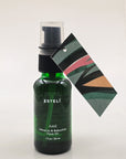 ESTELÍ Azul Hibiscus & Bakuchiol Face Oil in a 30 ml green glass pump bottle with a colorful abstract artwork tag.