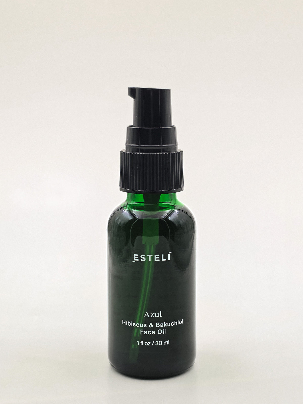 ESTELÍ Azul Hibiscus &amp; Bakuchiol Face Oil in a 30 ml green glass bottle with a black pump.