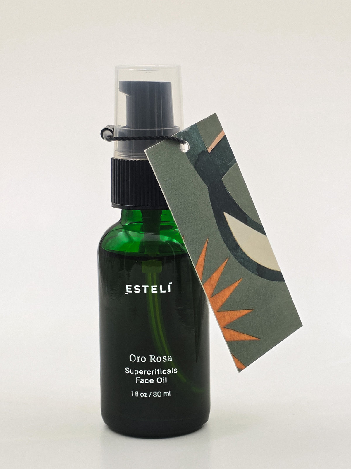 ESTELÍ Oro Rosa Supercriticals Face Oil in a green 30 ml pump bottle with an illustrated botanical hang tag.