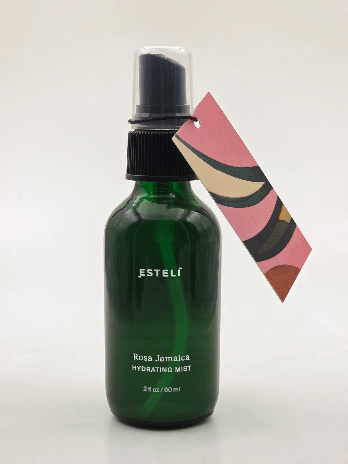 ESTELÍ Rosa Jamaica Hydrating Mist, 60 ml green glass spray bottle with a pink illustrated hang tag.