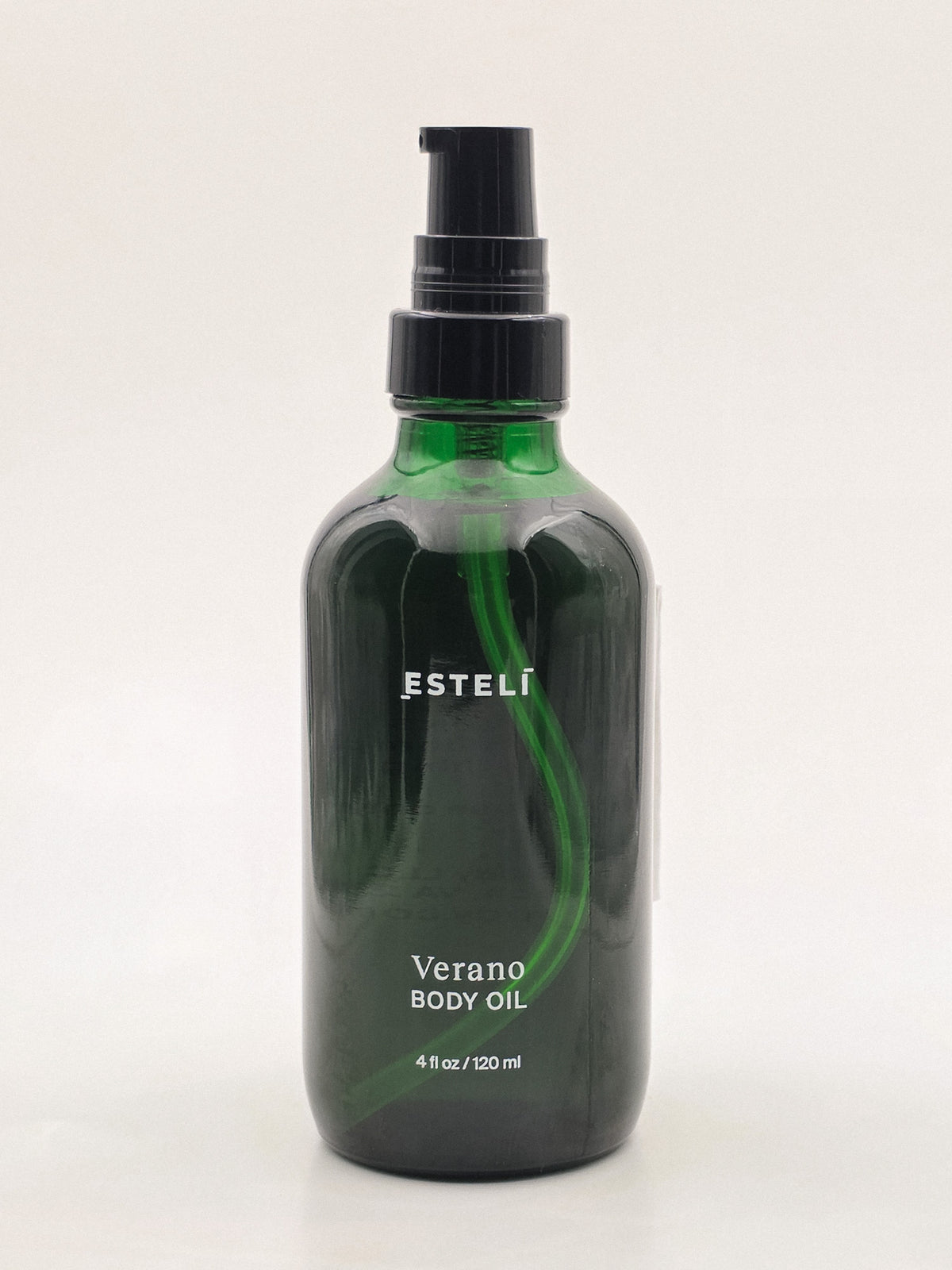 ESTELÍ Verano Body Oil in a green glass bottle with an uncovered black pump, 4 fl oz / 120 ml