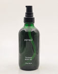 ESTELÍ Verano Body Oil in a green glass bottle with an uncovered black pump, 4 fl oz / 120 ml
