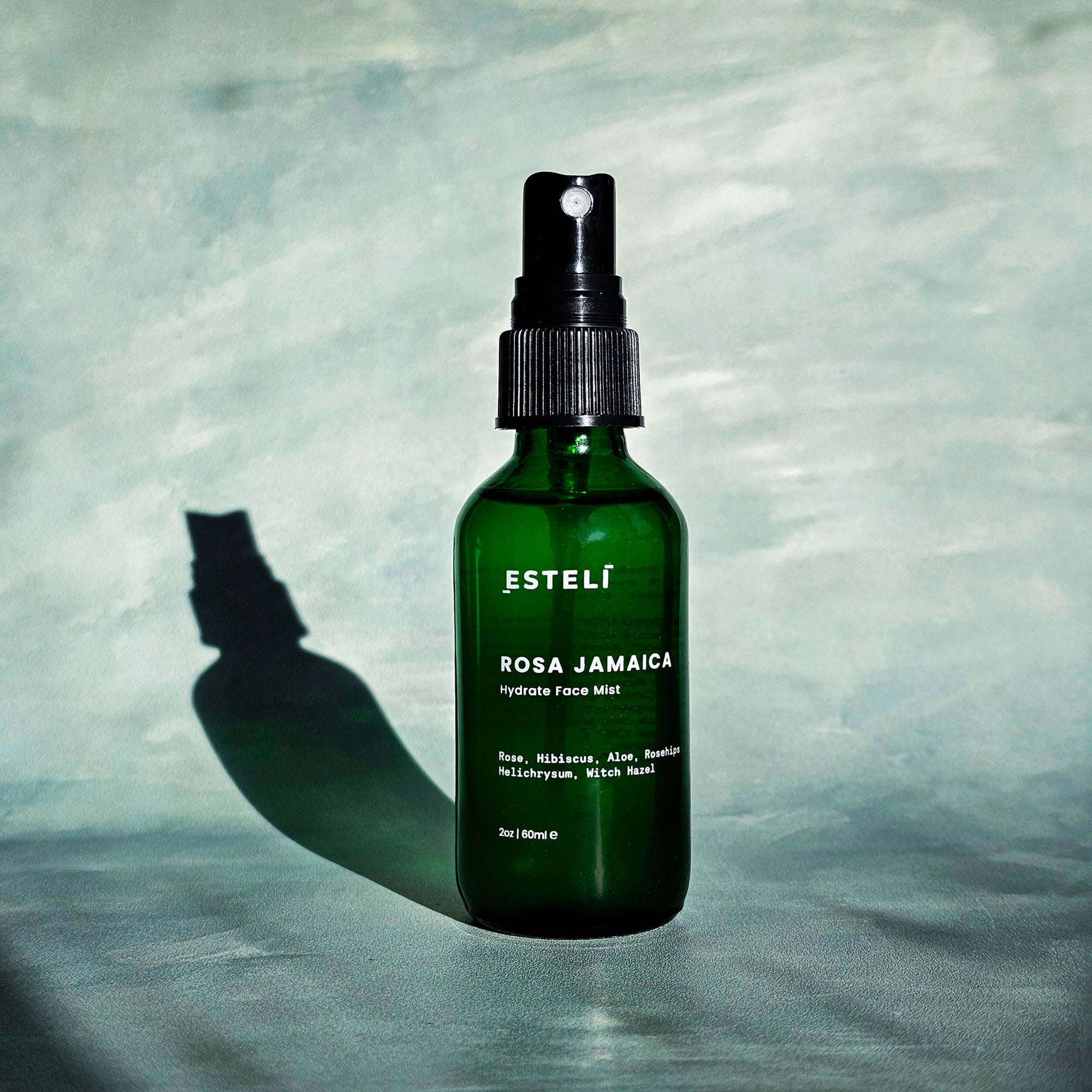 Rosa Jamaica Hydrating Face Mist in green glass bottle