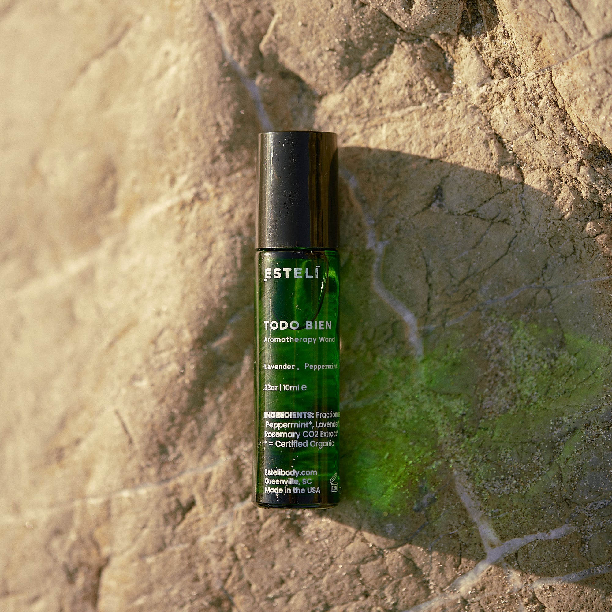 ESTELÍ Todo Bien Aromatherapy Roller on sunlit stone